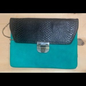 Women’s clutch bag with gold cross body strap